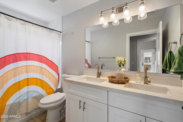 2604 N 27th St Unit 4, Phoenix, AZ 85008 - full bathroom featuring toilet, double vanity, curtained shower, and wood finished floors