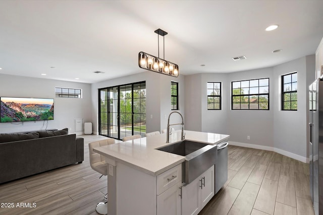 2604 N 27th St Unit 4, Phoenix, AZ 85008 - kitchen featuring open floor plan, a sink, appliances with stainless steel finishes, recessed lighting, and light countertops
