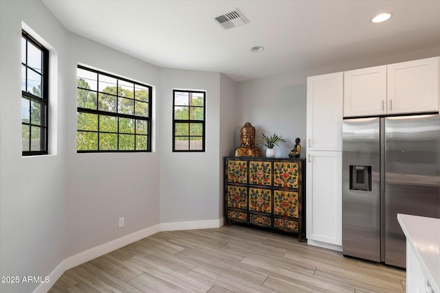 2604 N 27th St Unit 4, Phoenix, AZ 85008 - kitchen with stainless steel refrigerator with ice dispenser, light wood-style flooring, white cabinetry, baseboards, and recessed lighting