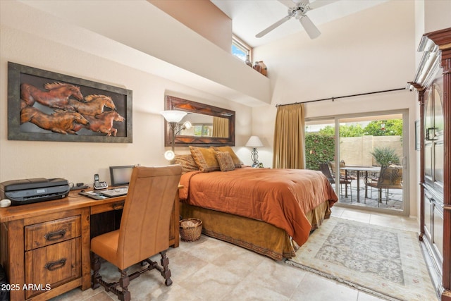 bedroom featuring a ceiling fan, access to outside, and a high ceiling