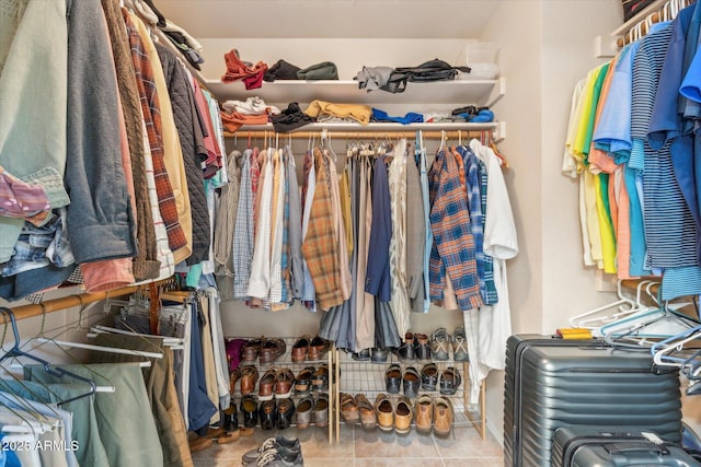 walk in closet featuring tile patterned flooring