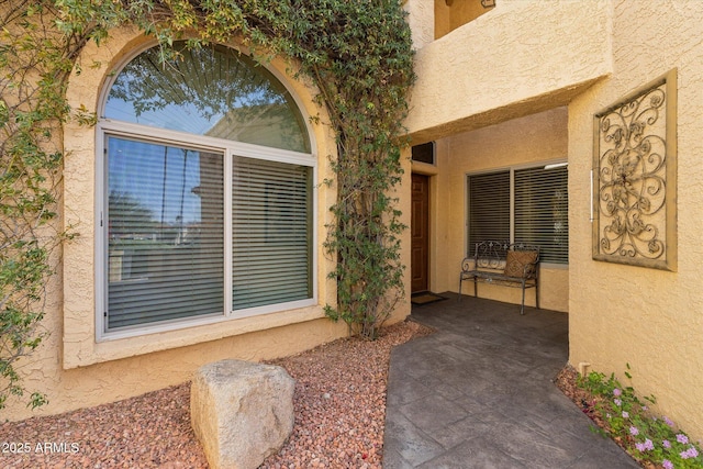 entrance to property with stucco siding