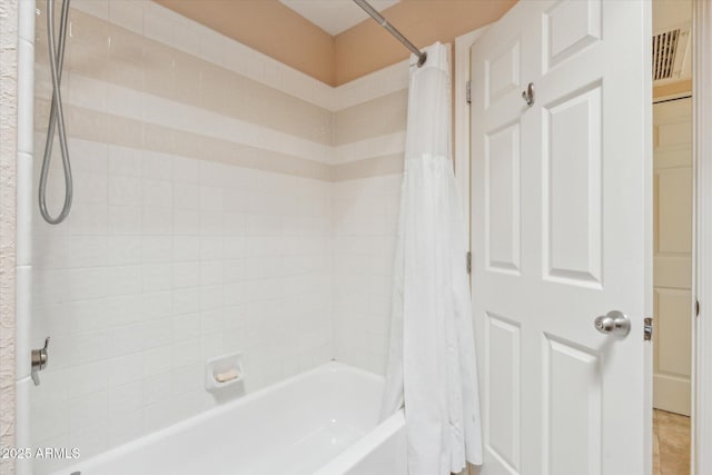 bathroom featuring visible vents and shower / bathtub combination with curtain