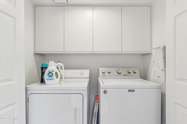 washroom with cabinet space and washing machine and dryer