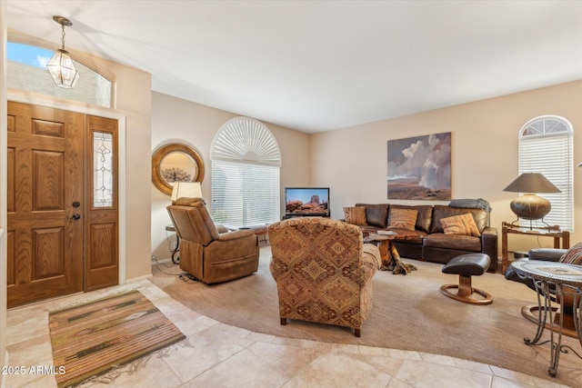 entryway with light carpet, plenty of natural light, and light tile patterned flooring