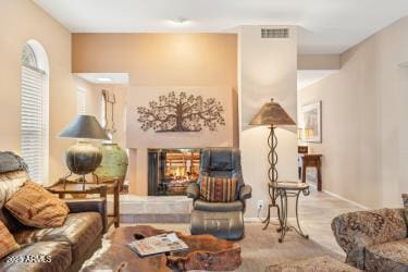 interior space with carpet, a multi sided fireplace, and visible vents