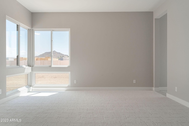 carpeted empty room with a mountain view