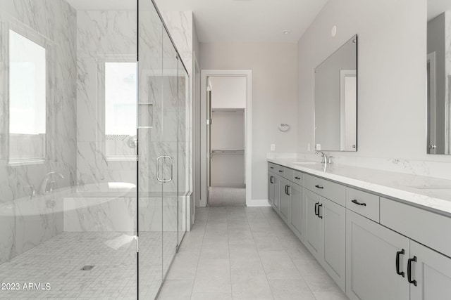 bathroom featuring tile patterned flooring, vanity, and a shower with door