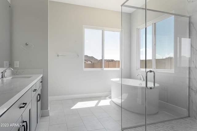 bathroom with tile patterned flooring, vanity, plenty of natural light, and independent shower and bath