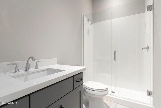 bathroom with tile patterned floors, vanity, toilet, and walk in shower