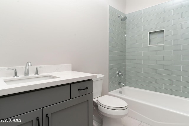 full bathroom with tile patterned floors, vanity, toilet, and tiled shower / bath combo