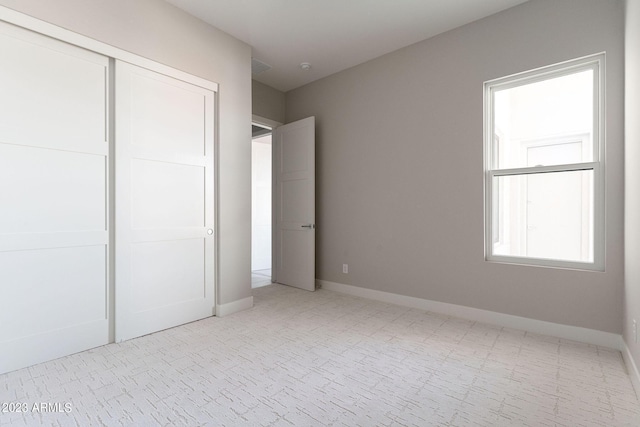 unfurnished bedroom with a closet