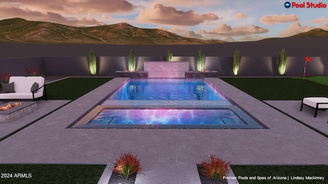 pool at dusk featuring a mountain view and a patio area