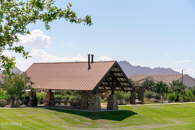 view of property's community featuring a lawn, a mountain view, and a gazebo