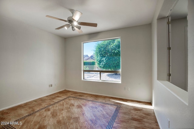 spare room with ceiling fan and light hardwood / wood-style floors