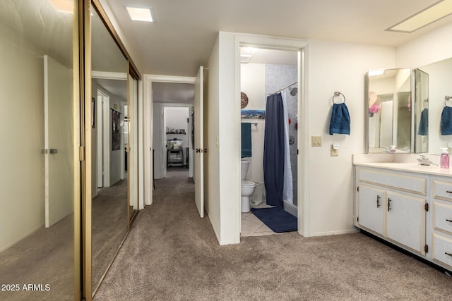 bathroom featuring walk in shower, vanity, and toilet