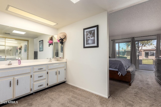 bathroom with vanity and a textured ceiling