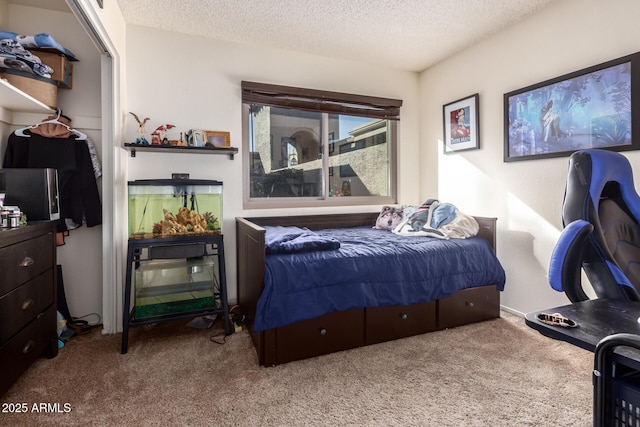 carpeted bedroom featuring a textured ceiling