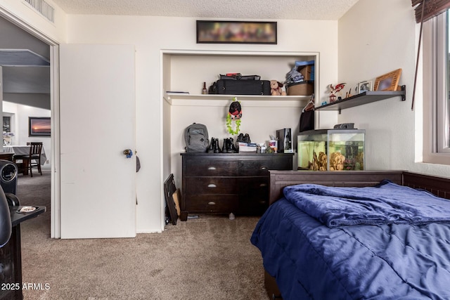 bedroom with carpet flooring and a textured ceiling