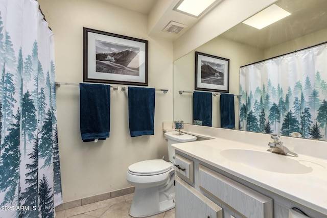 bathroom featuring tile patterned flooring, vanity, and toilet