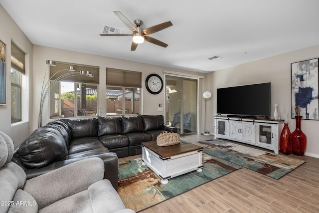 living room featuring hardwood / wood-style flooring and ceiling fan