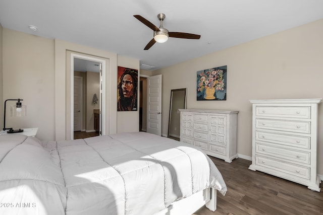 bedroom featuring dark wood-type flooring, ceiling fan, and ensuite bathroom