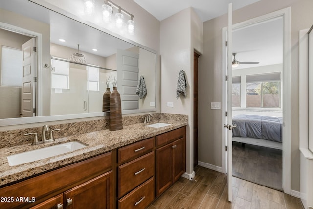 bathroom featuring wood-type flooring, vanity, ceiling fan, and walk in shower