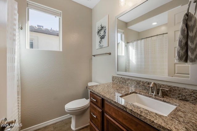 bathroom featuring vanity, curtained shower, wood-type flooring, and toilet