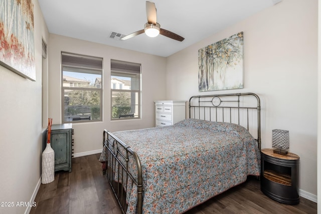 bedroom with ceiling fan and dark hardwood / wood-style flooring