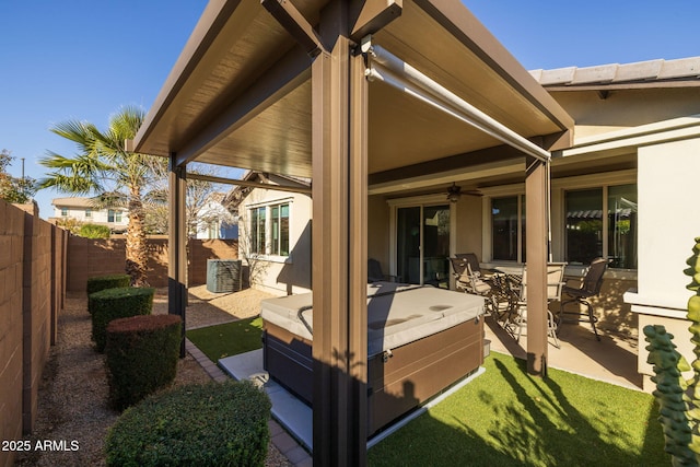 back of property featuring a patio area, ceiling fan, and a jacuzzi