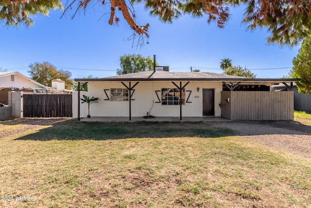 rear view of house with a yard