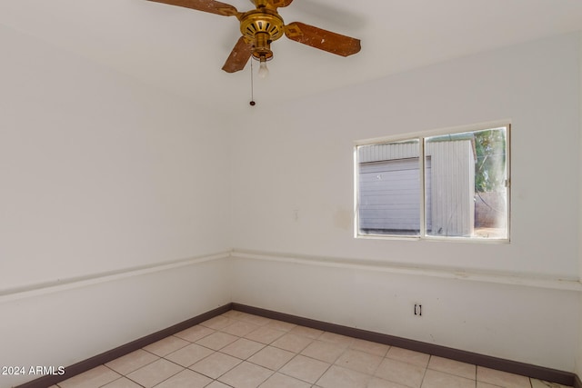 tiled spare room featuring ceiling fan