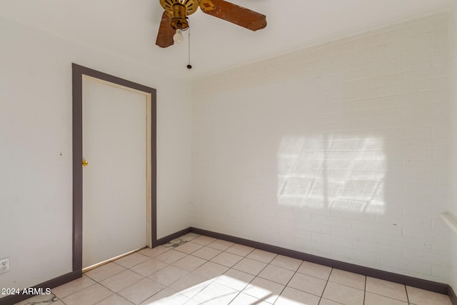 empty room with light tile patterned floors and ceiling fan