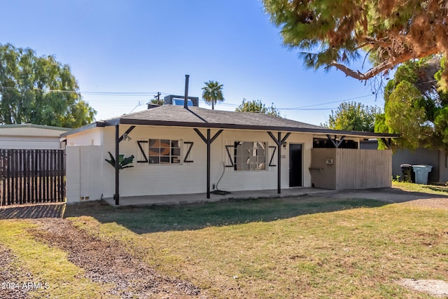 back of property featuring a lawn