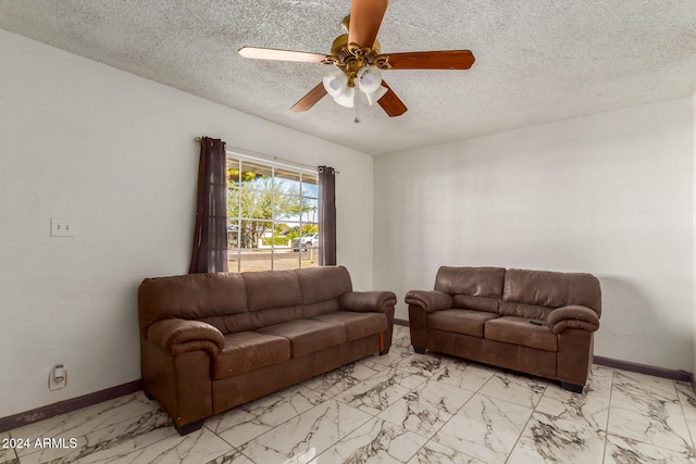 living room with ceiling fan and a textured ceiling