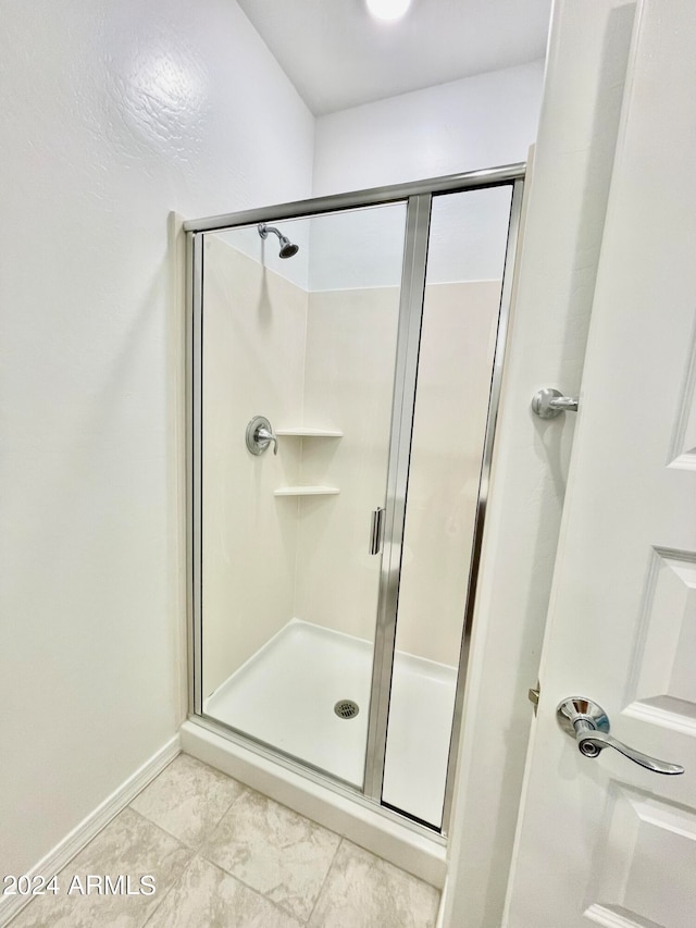 bathroom featuring tile patterned flooring and walk in shower