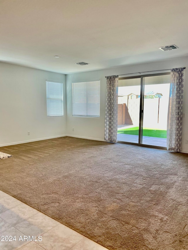 unfurnished room with light carpet