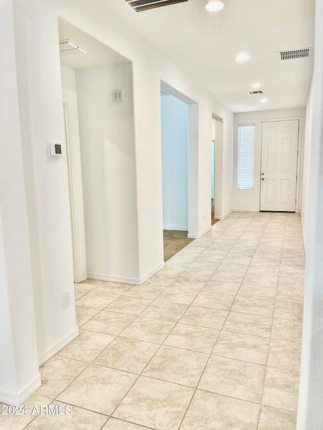 hallway featuring light tile patterned flooring