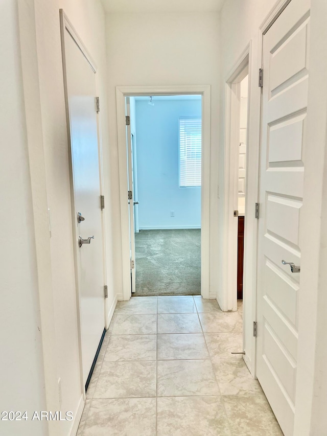 hallway with light colored carpet