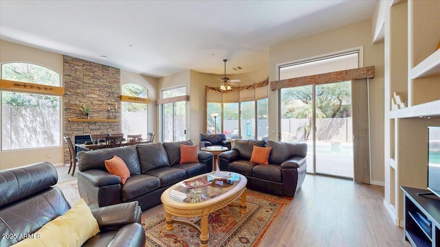 living room with ceiling fan, hardwood / wood-style flooring, and baseboards