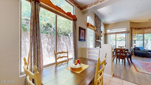 dining room featuring tile patterned flooring and a healthy amount of sunlight