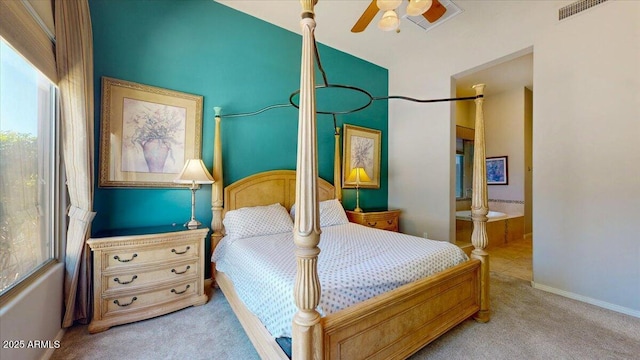 carpeted bedroom with baseboards, visible vents, and ensuite bath