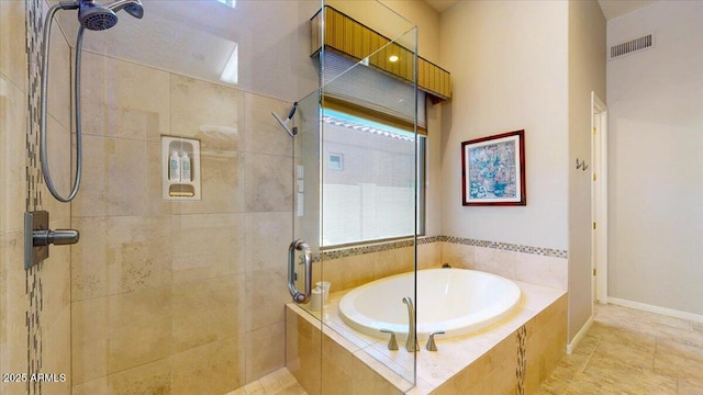 bathroom featuring a garden tub, visible vents, tiled shower, and baseboards