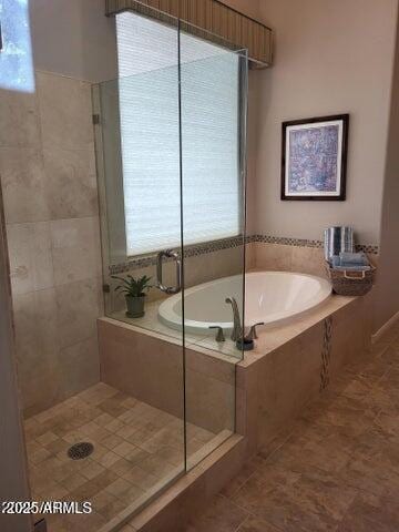 full bathroom with a garden tub, a healthy amount of sunlight, a tile shower, and tile patterned flooring