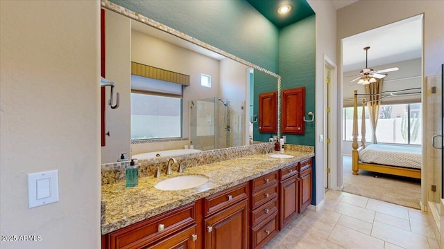 ensuite bathroom with a sink, a shower stall, ensuite bath, a ceiling fan, and double vanity
