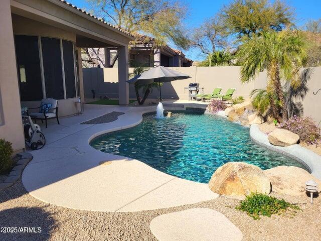 view of pool featuring a fenced in pool, a fenced backyard, and a patio area