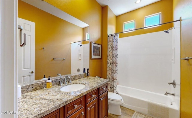 full bath featuring wood finished floors, shower / bath combination with curtain, toilet, and vanity