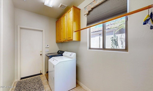 washroom featuring independent washer and dryer, light tile patterned floors, cabinet space, baseboards, and visible vents