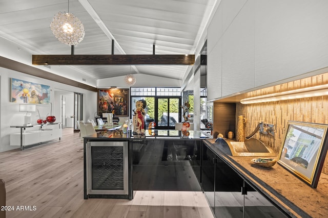 bar featuring light wood-type flooring, wooden walls, decorative light fixtures, vaulted ceiling with beams, and wine cooler