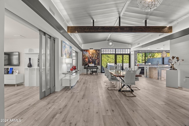 sunroom / solarium with a chandelier, sink, and lofted ceiling with beams